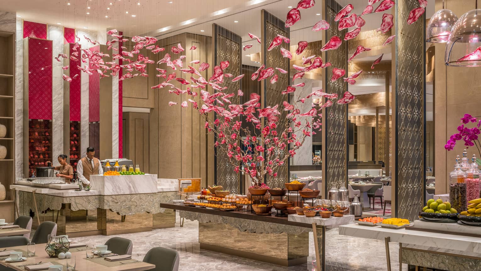 Curate buffet table with fruits and vegetables and servers arranging food