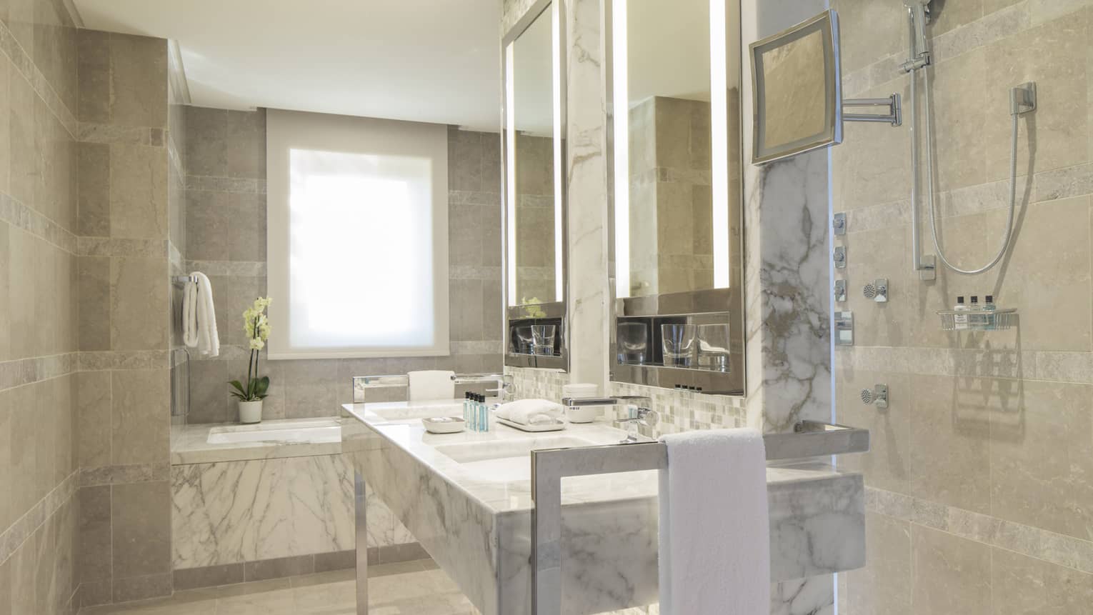 Executive Suite full white and grey marble bathroom, vanity with double sink, tub