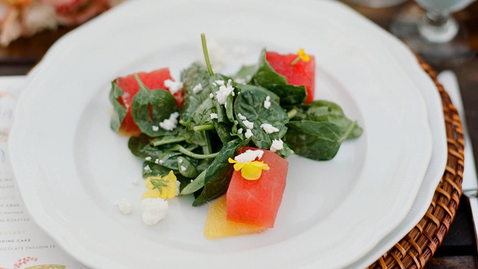 Gourmet spinach salad with watermelon cubes and crumbled goat cheese