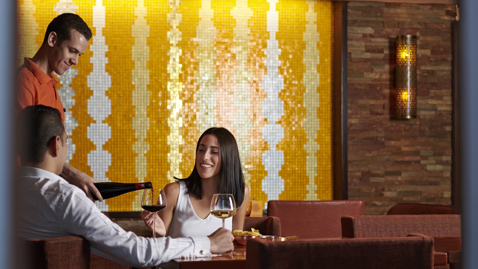 Couple enjoys a casual meal with wine at Aura