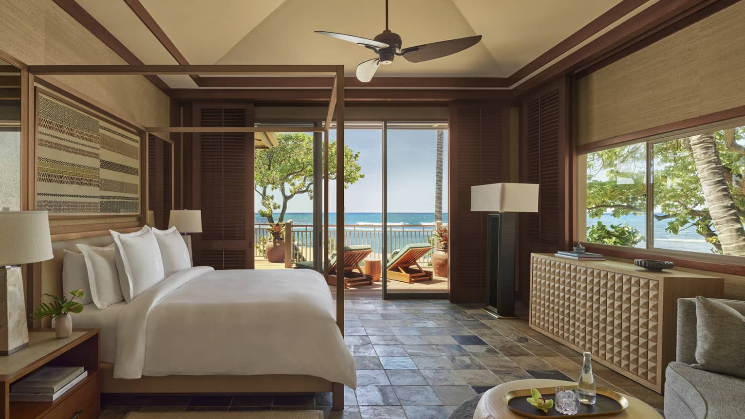 Bedroom with stone tile, four-poster king bed, natural colours, walk-out beach terrace