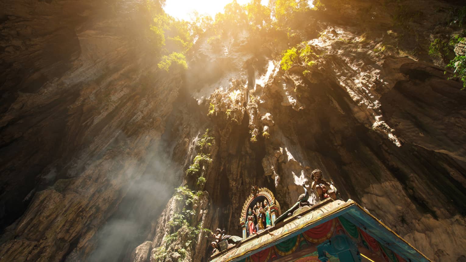 View looking up at rocks through Hindu temple at Batu caves in Malaysia