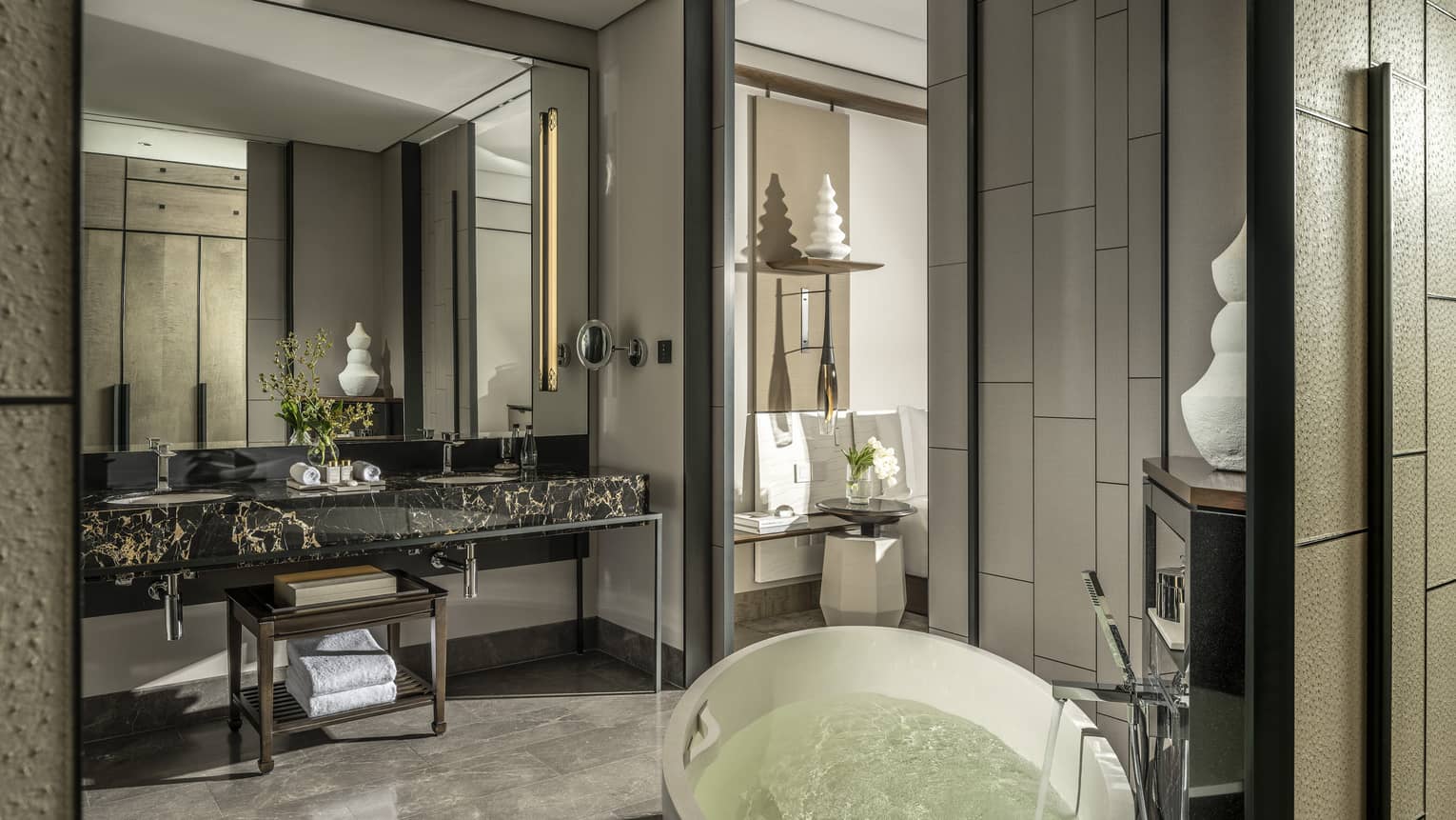 Guest bathroom, large mirror, standalone white tub, opening to bedroom