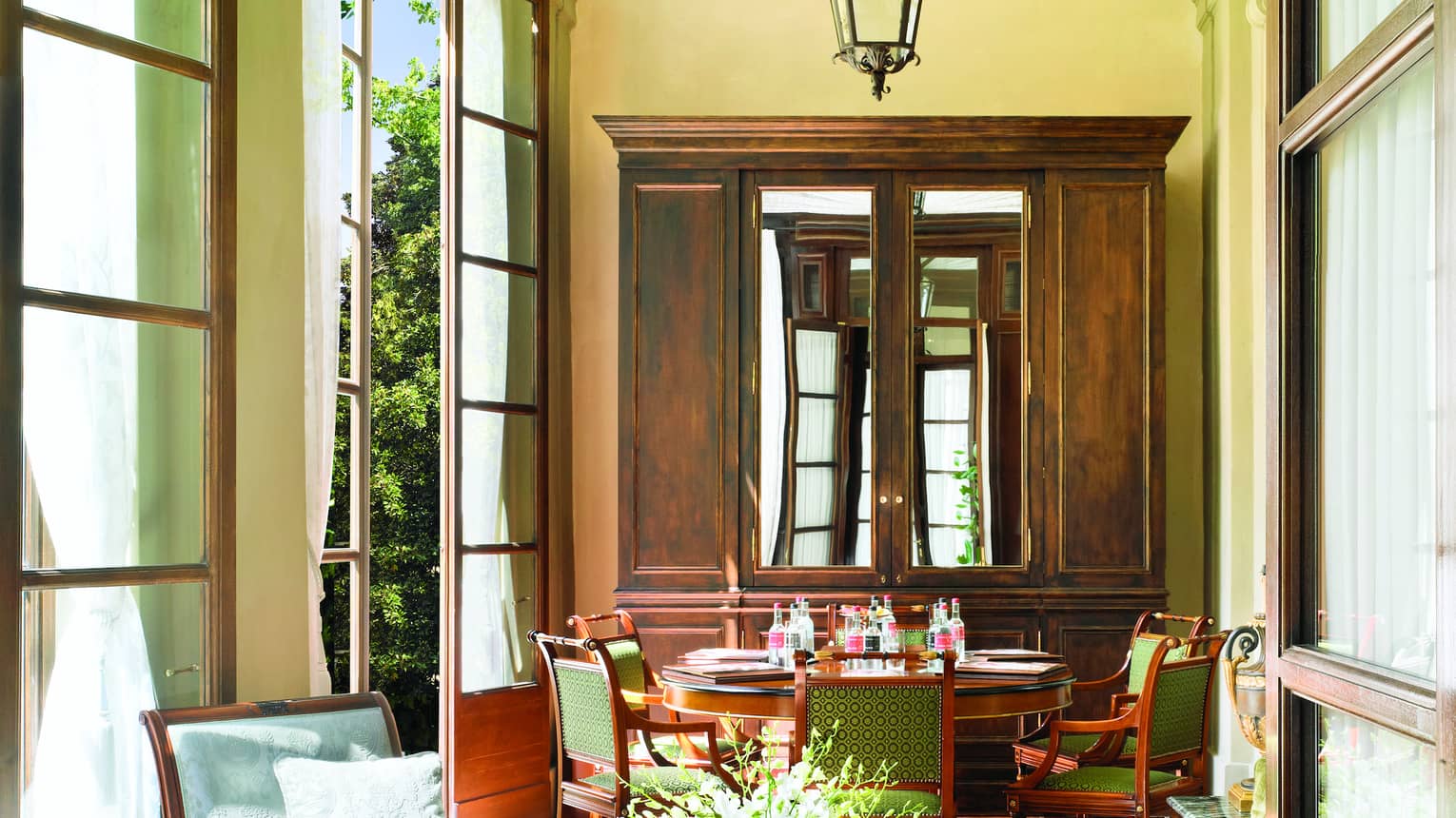 Pinti Room, lantern hangs from arched ceiling over sunny seating area