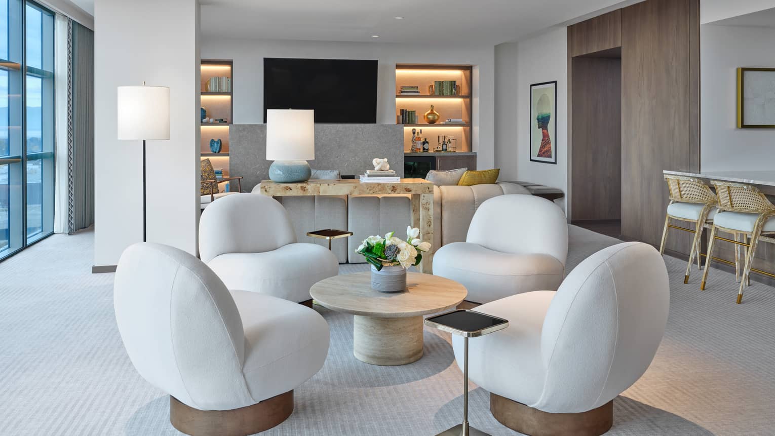Living room with four modern chairs set around a round coffee table