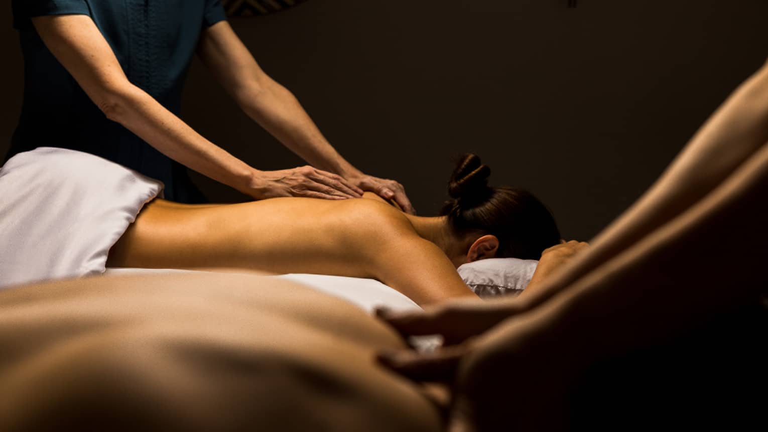 Two guests lay side by side for massage treatments
