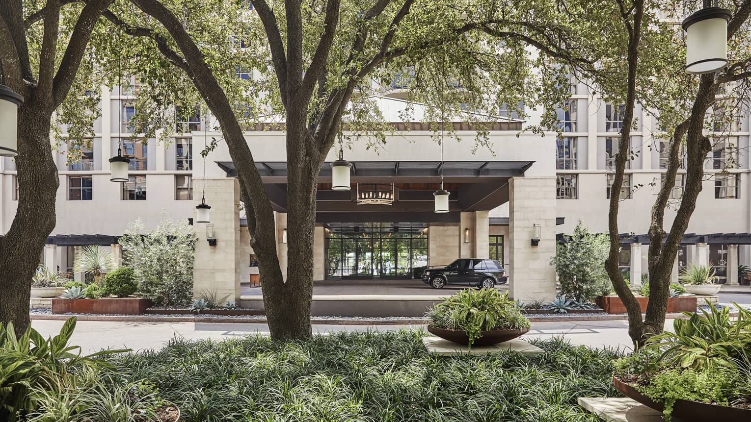 Trees line the entrance to the Four Seasons Hotel in Austin