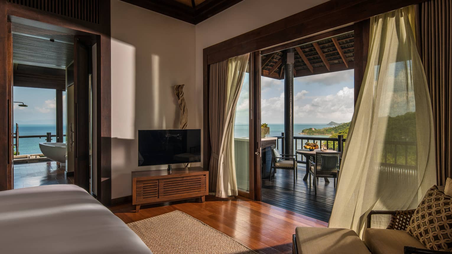 Bedroom looking out on a terrace with a view of the Gulf of Thailand