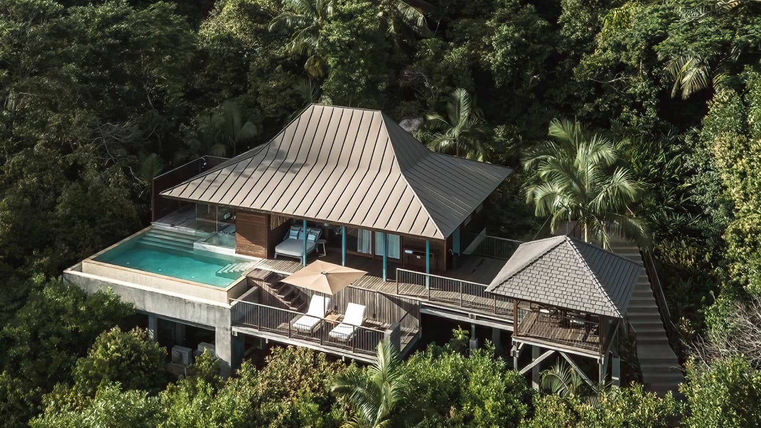 Private villa with private pool and expansive decking, nestled amid tropical foliage