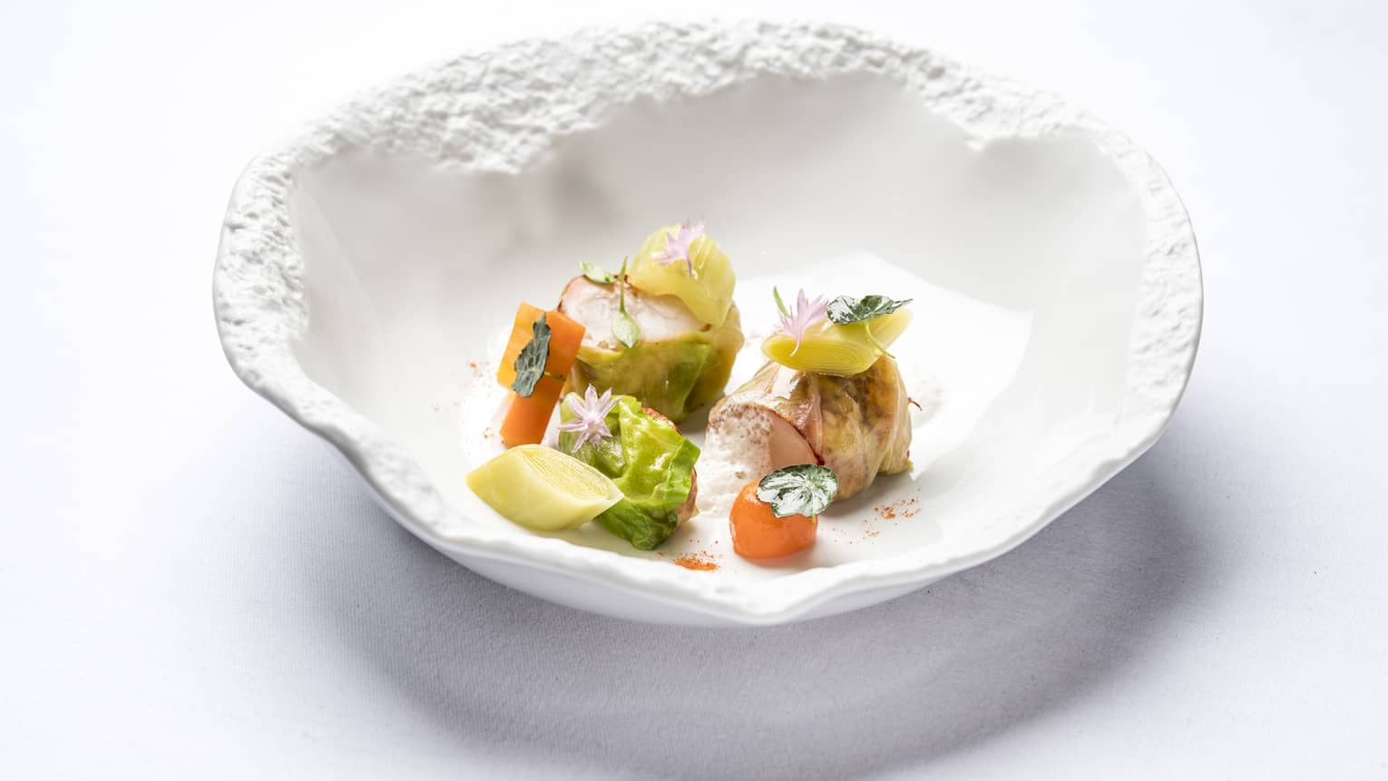 Blue Lobster Nage in artistic white bowl