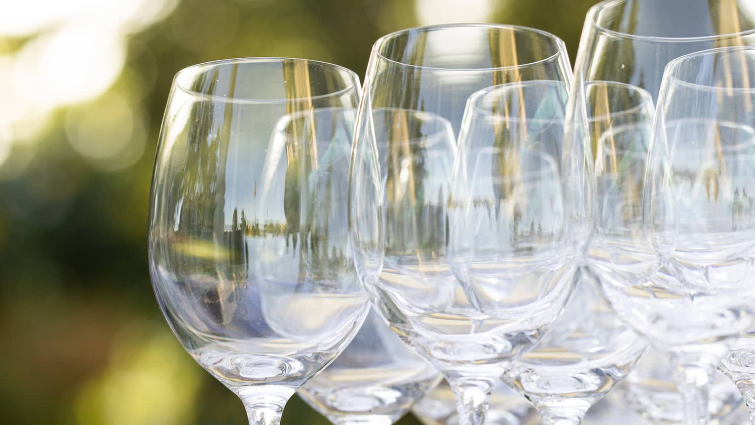 Empty wine glasses grouped together on an outdoor table