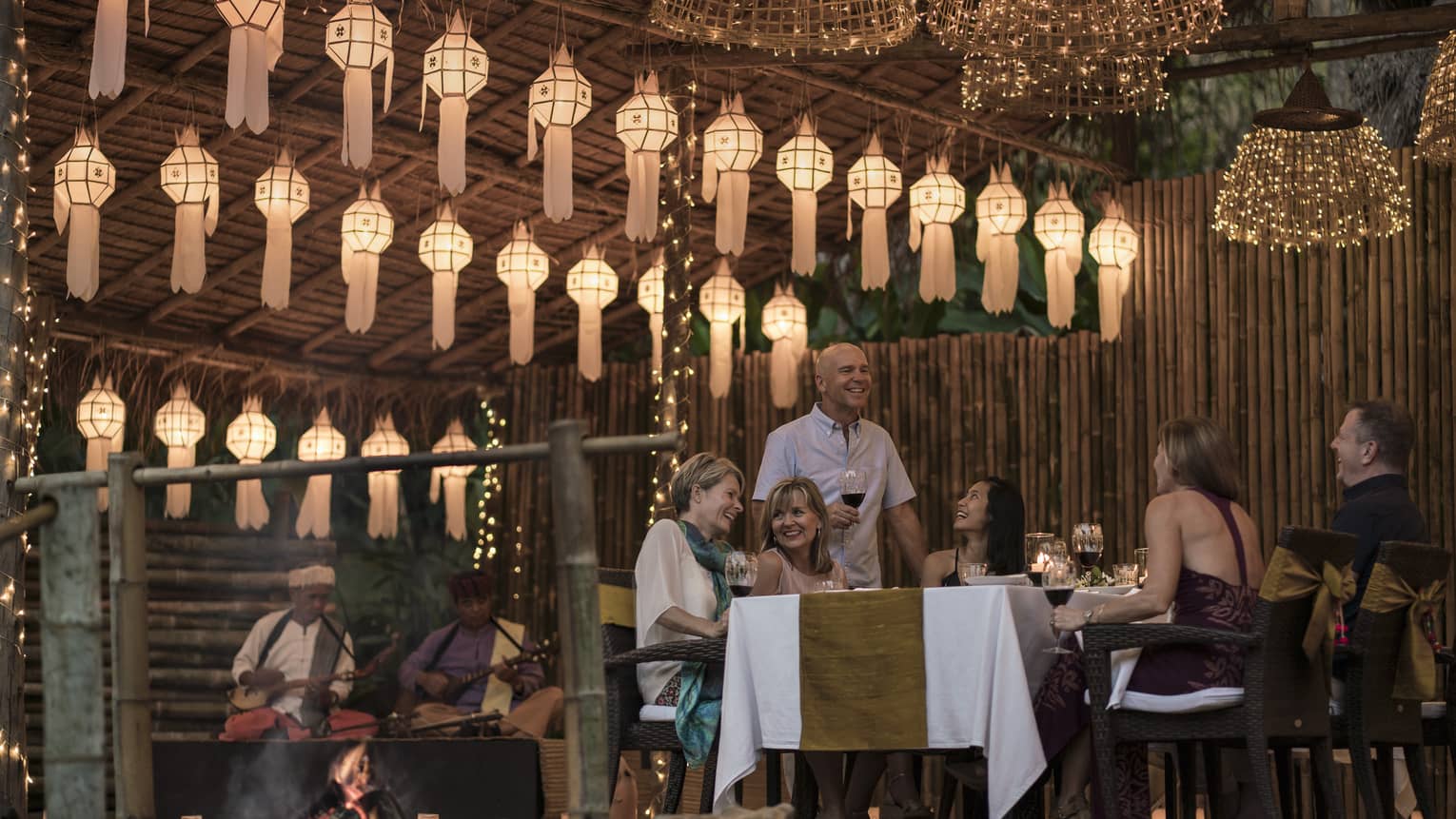Elephant Camp Dinner, smiling group of diners unders rows of paper lanterns