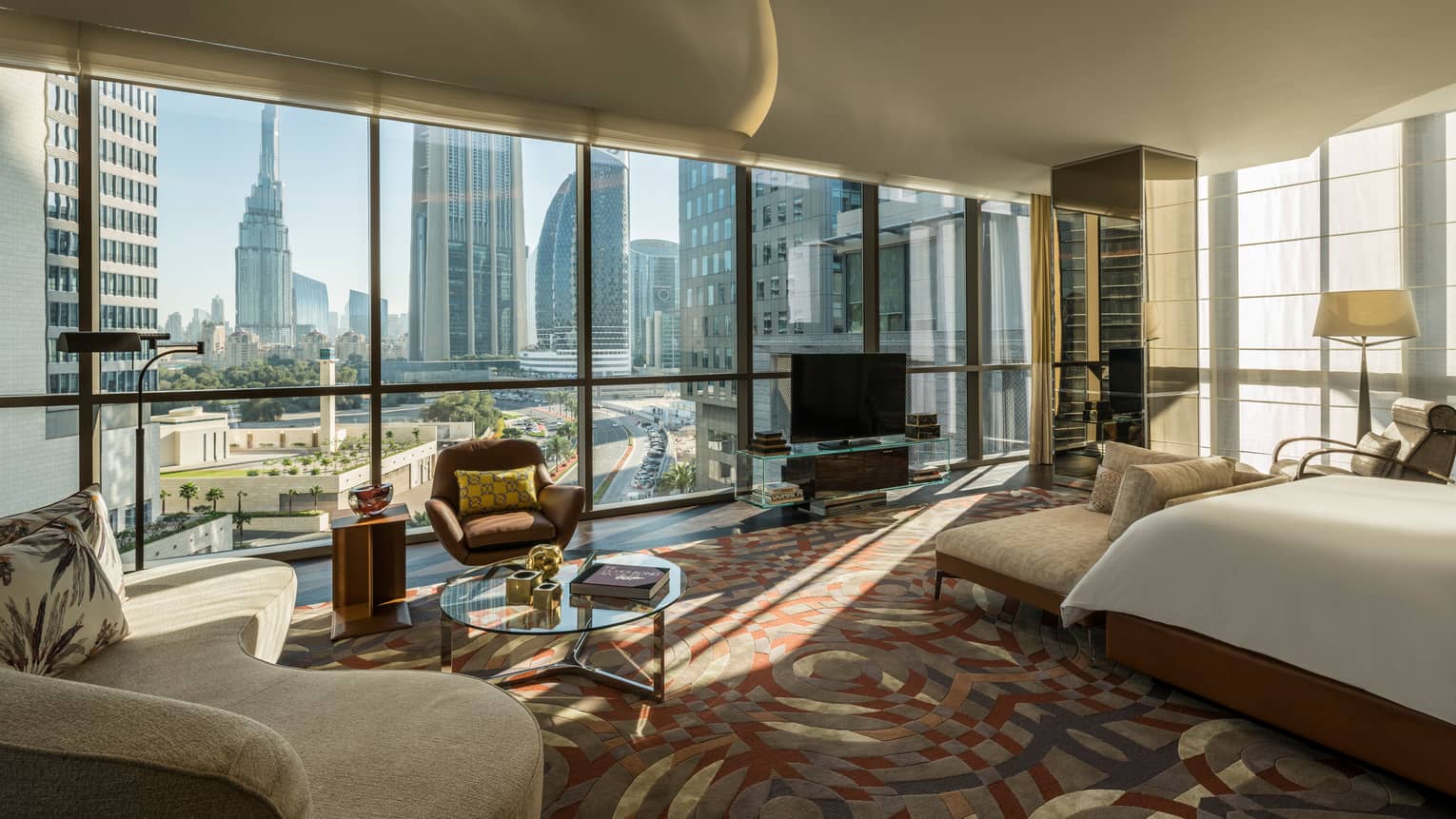 Bright Penthouse Suite with bed, sofa in front of wall of floor-to-ceiling windows with Dubai city views 