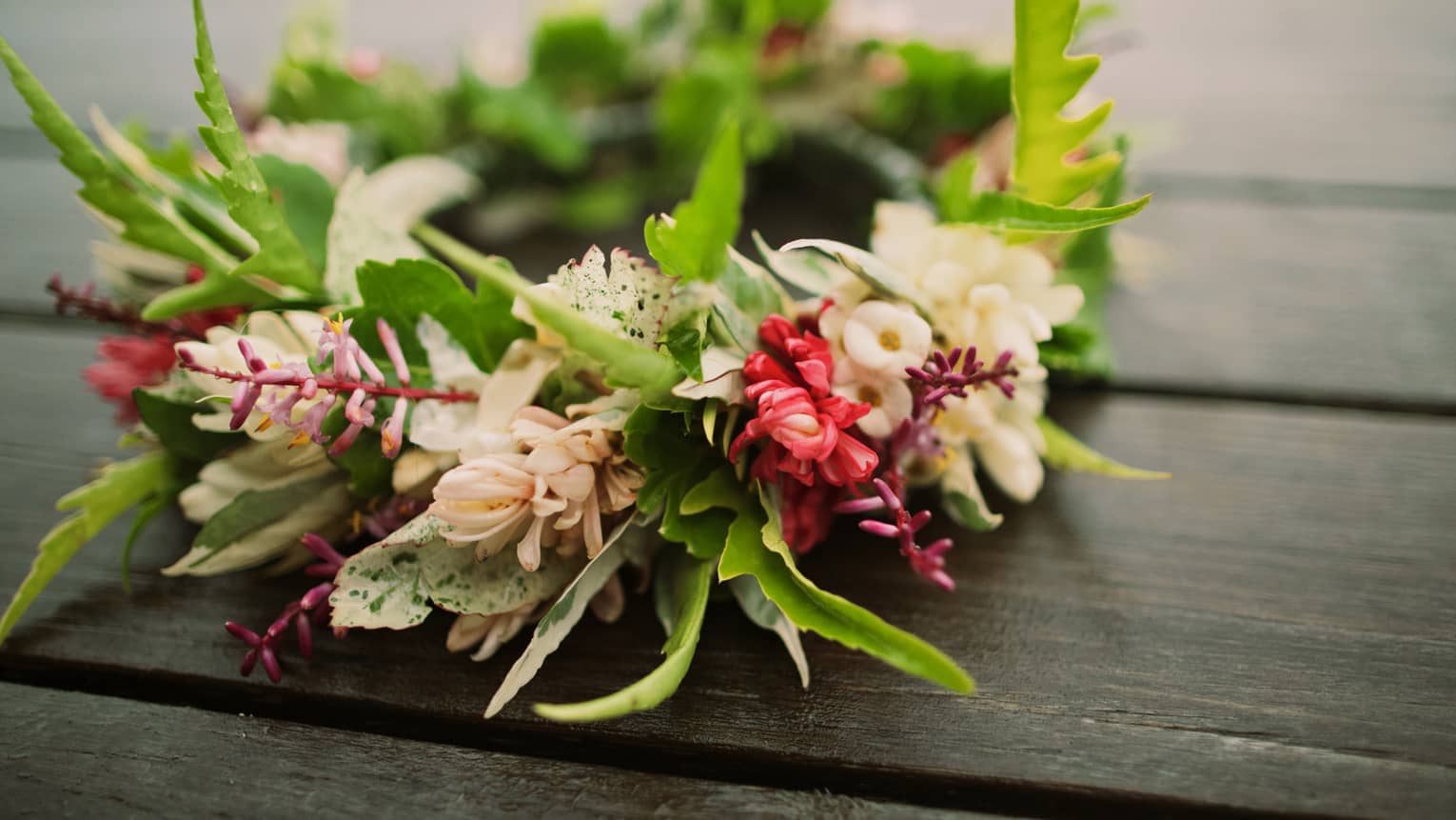 Tropical flowers arranged in floral wedding crown on table