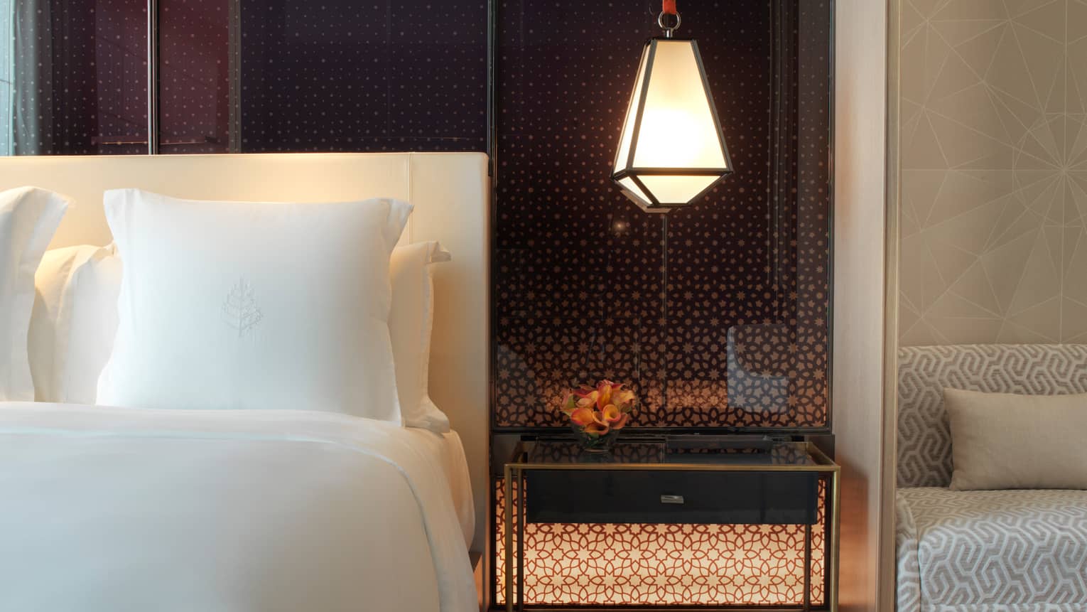 Superior Room modern lantern hanging above nightstand beside white pillow, bed