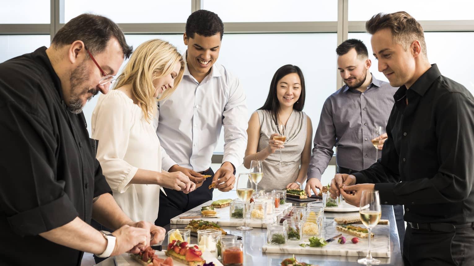 Chef assembles appetizer platters at group cooking class 