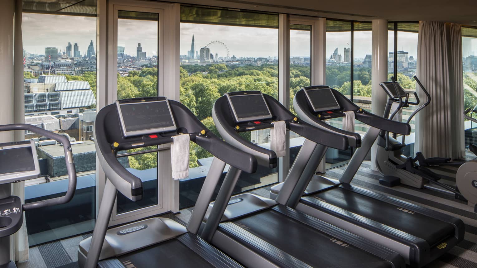 Fitness Centre treadmills in row by window with London skyline views