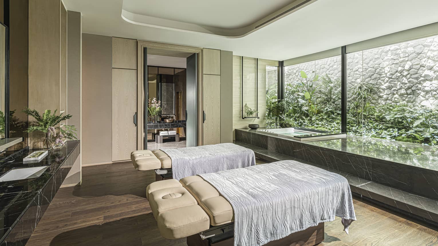 Couples treatment room with floor-to-ceiling windows and natural light