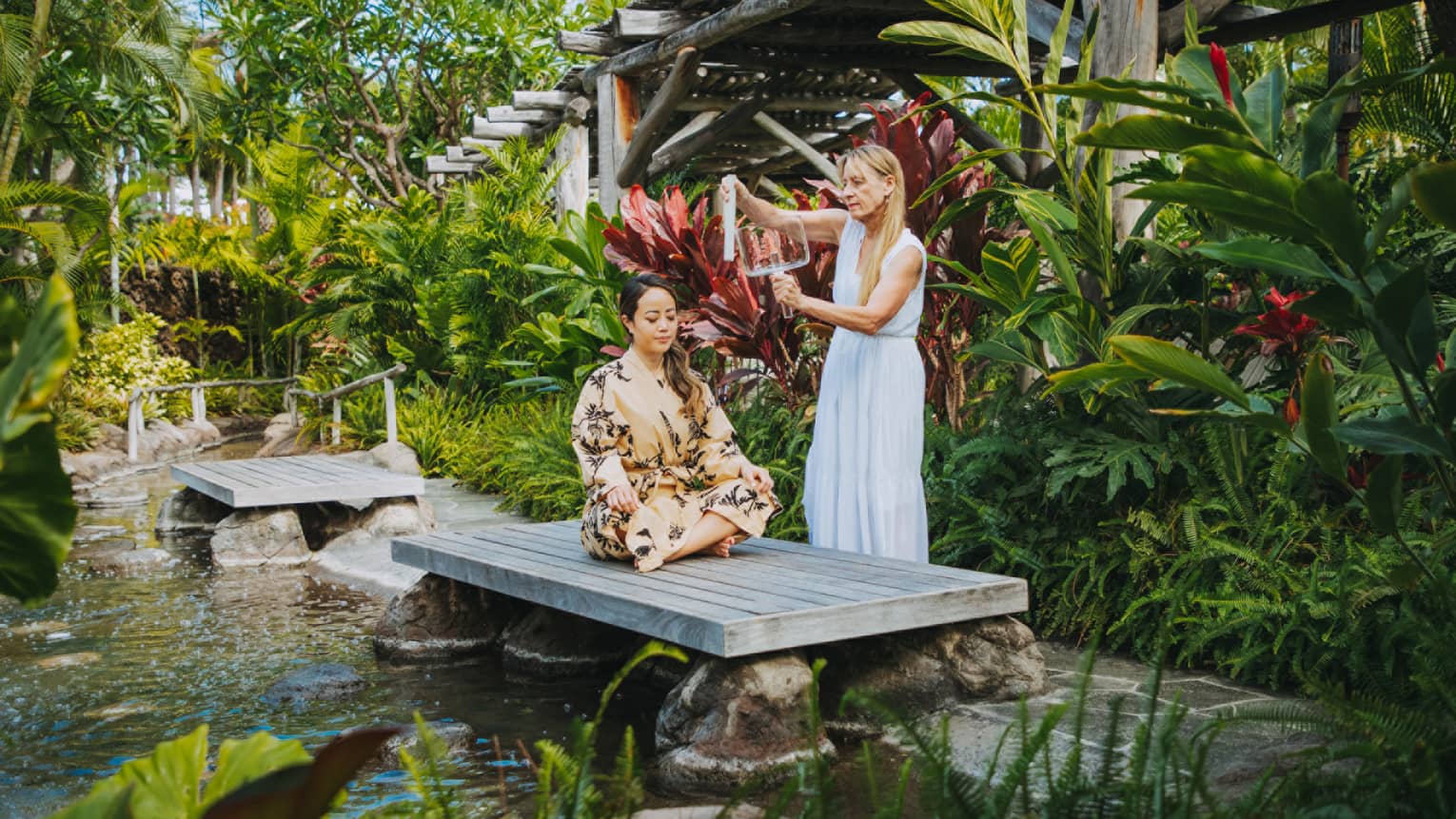 A guest having a relaxing spa treatment outside in Hualalai