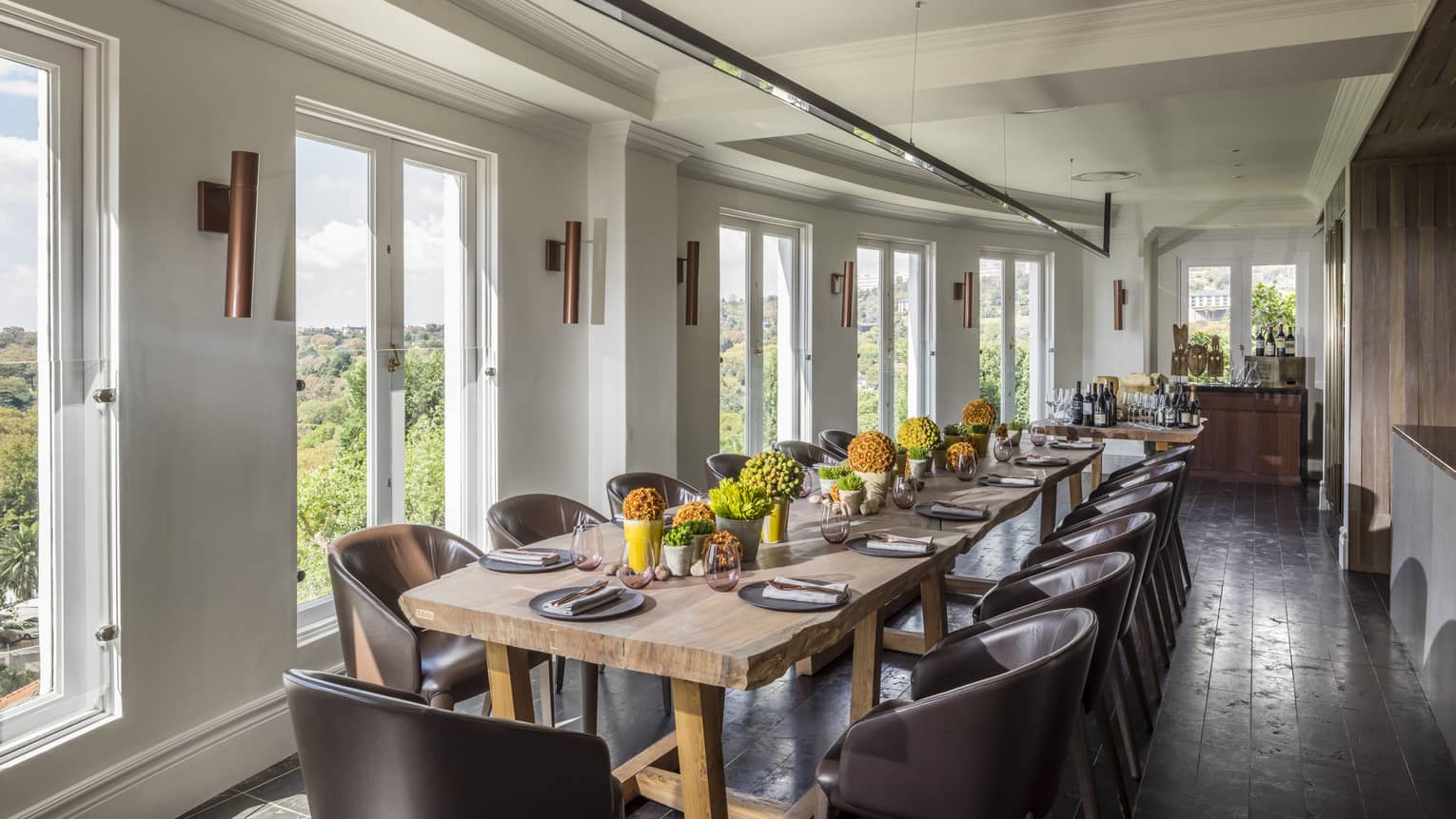 Long dining table with flowers in bright Cellar Door Show Kitchen 