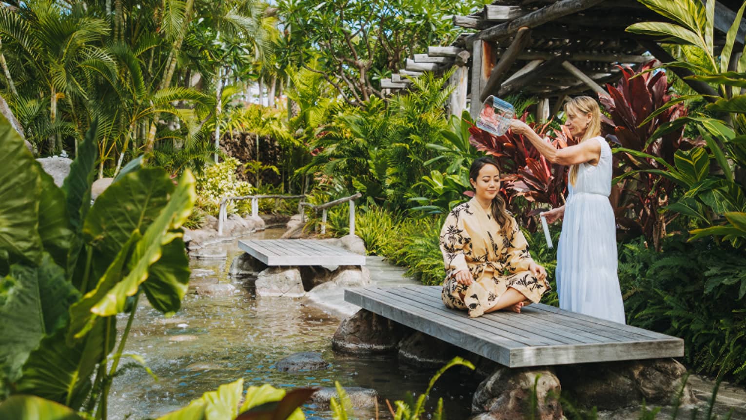 A guest at our Hualalai spa enjoying a bespoke treatment in a tranquil garden setting