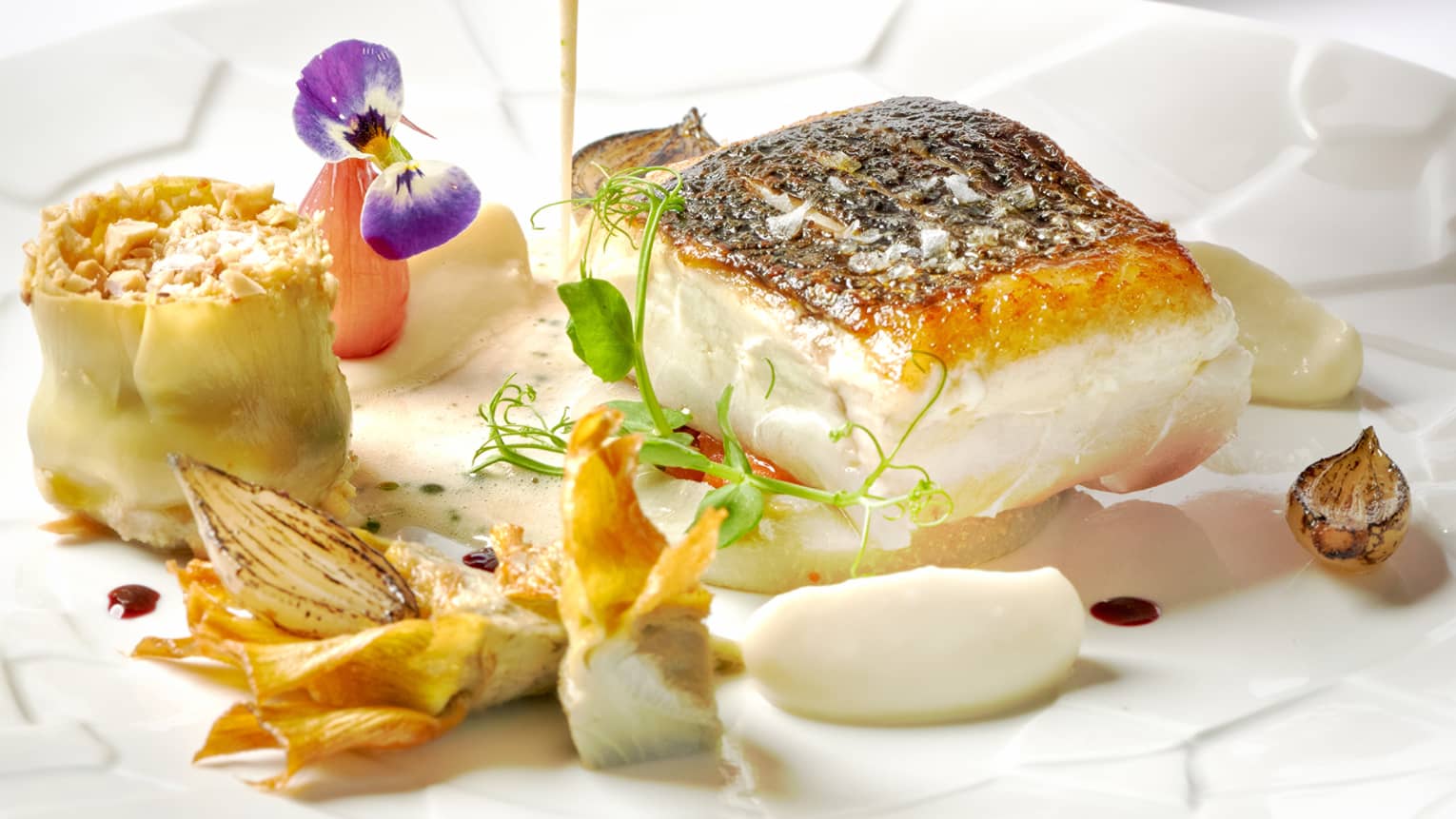 Wild sea bass, violets artichokes and Vesuvio Falanghina sauce