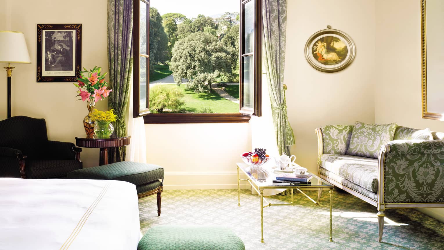 Four Seasons Room silk sofa, armchair, table under large open window overlooking gardens