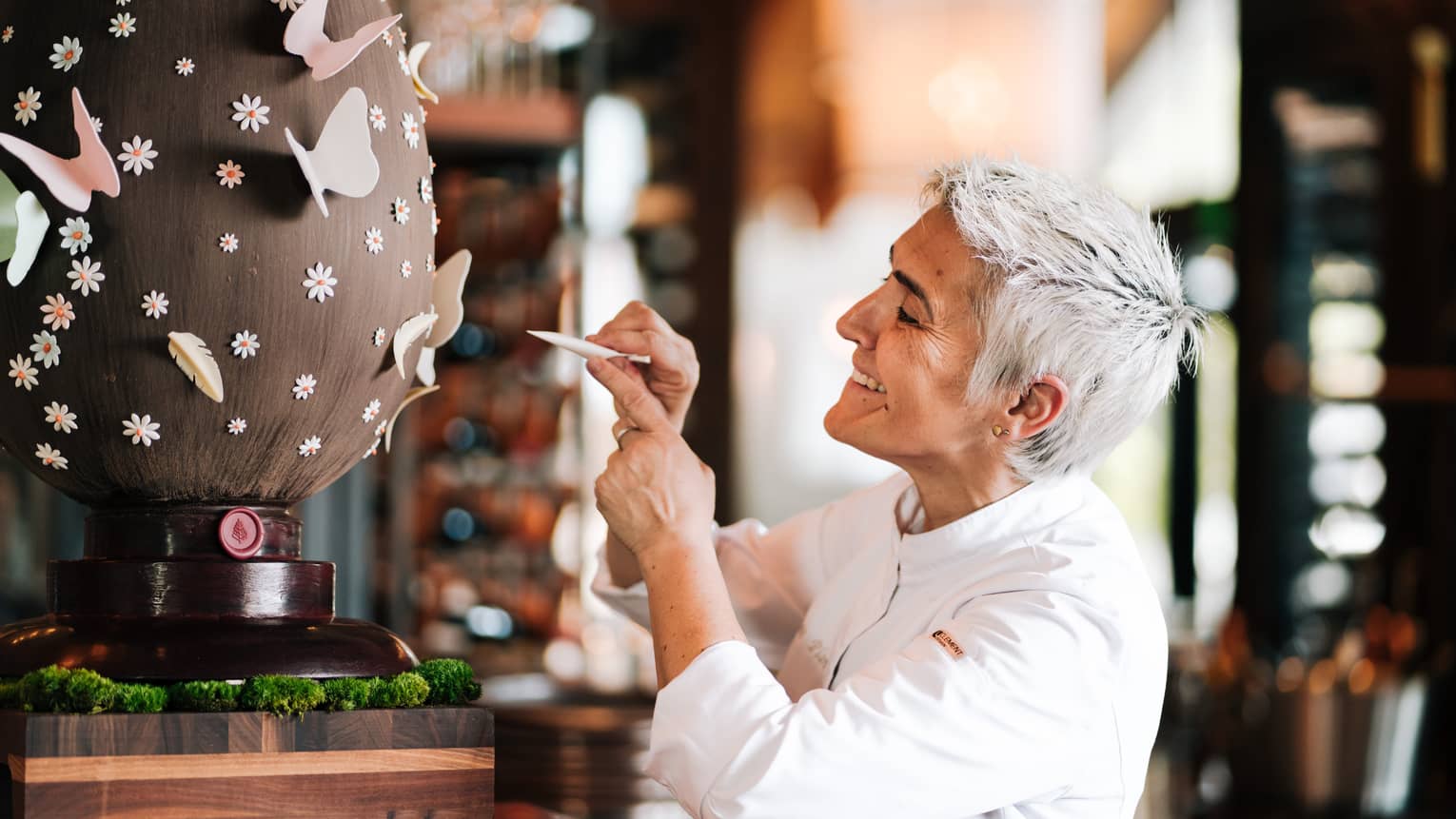 A chef decorates a giant chocolate egg