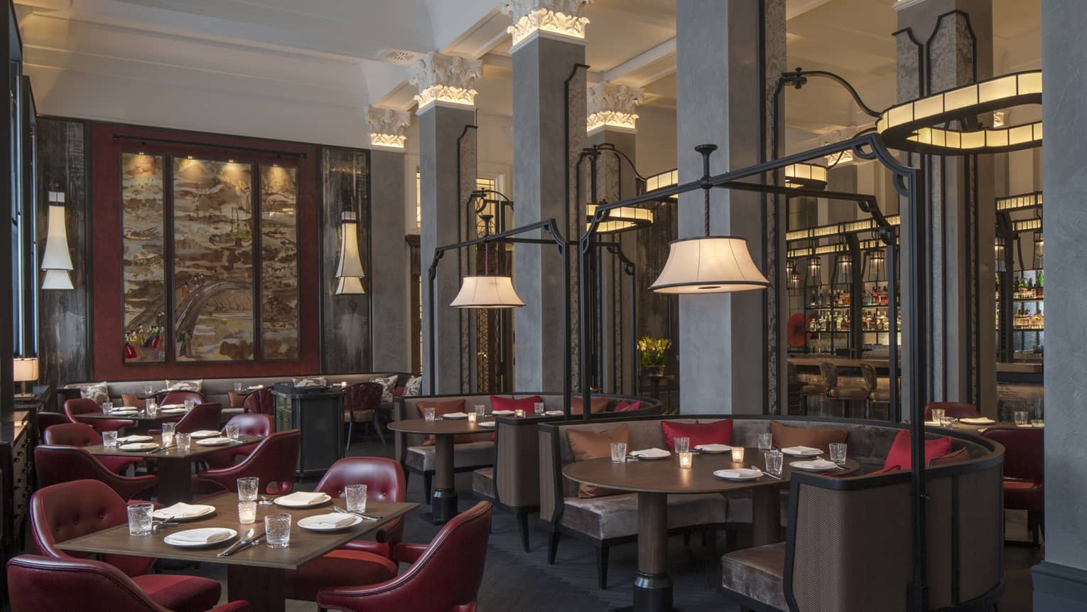Wide view of Mei Ume dining area, brown tables and booths with red chairs, red and brown accent pillows