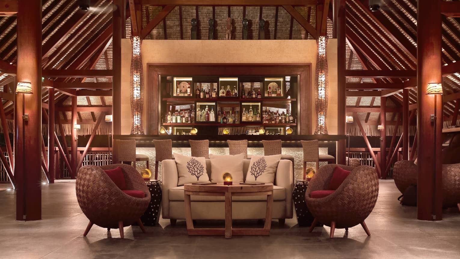 Sunset Bar with three steps leading to small seating area and bar under tall beamed ceiling