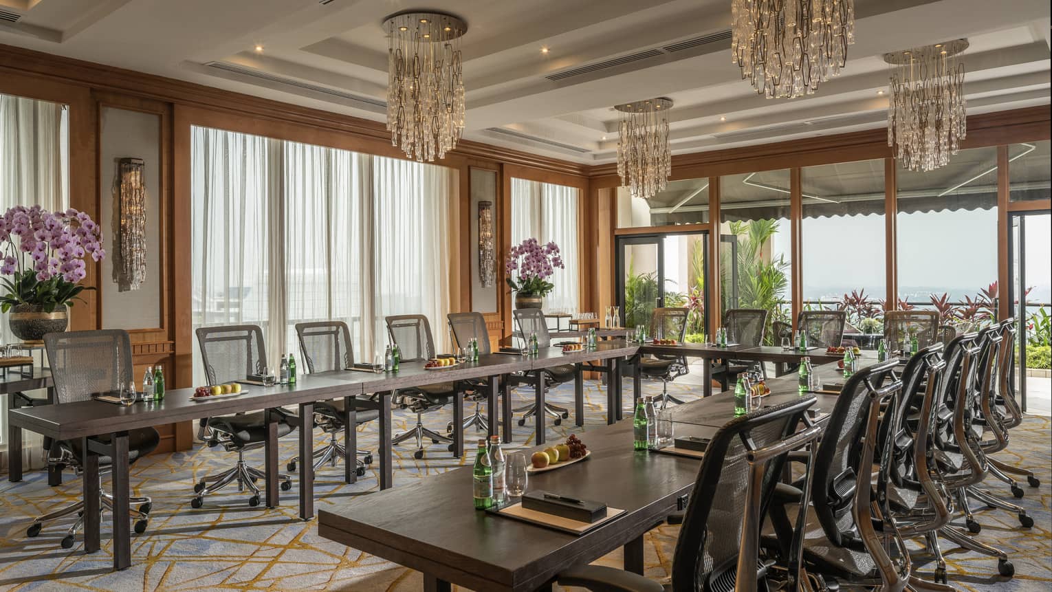 A bright room has chairs and tables arranged for a meeting