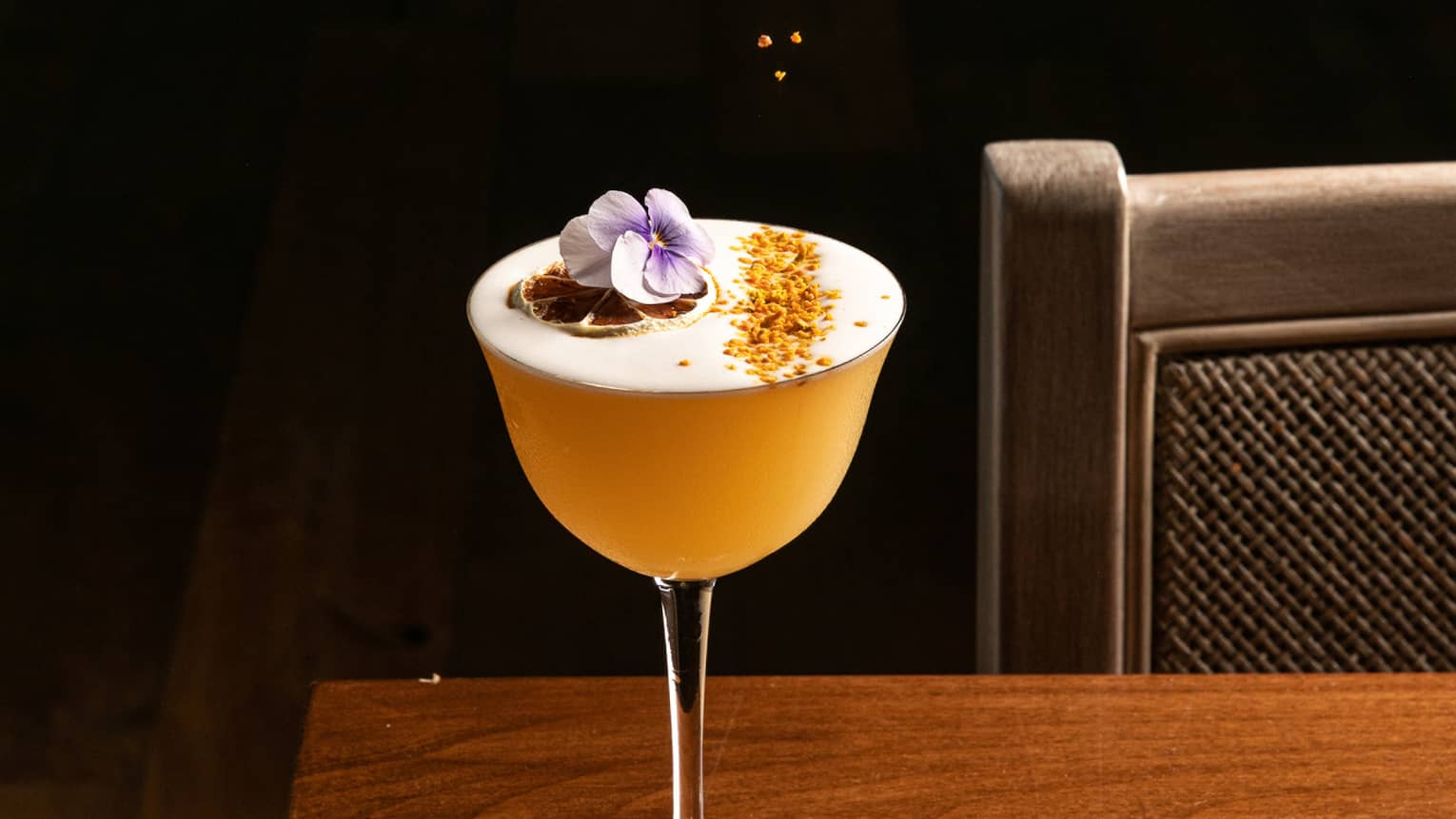 A cocktail being garnished.