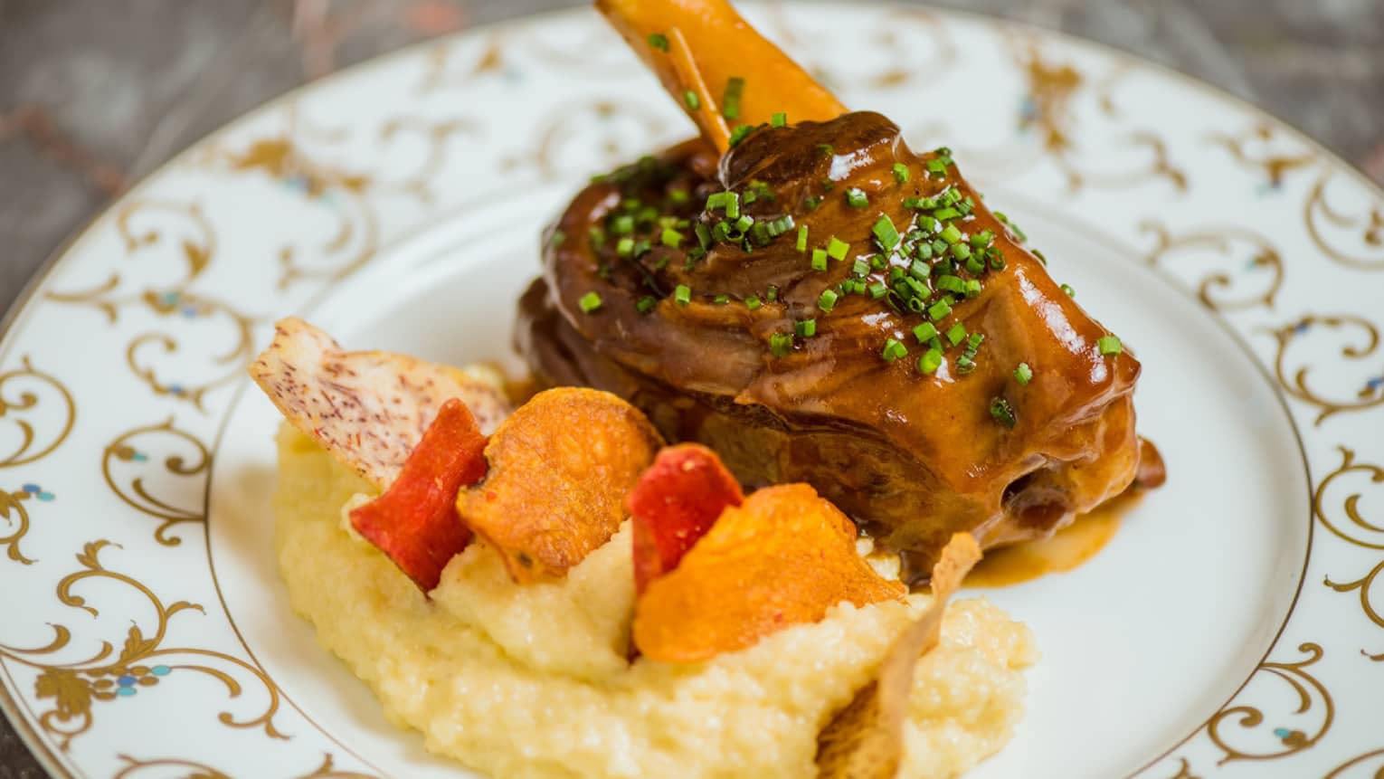 A lamb shank with a side of couscous
