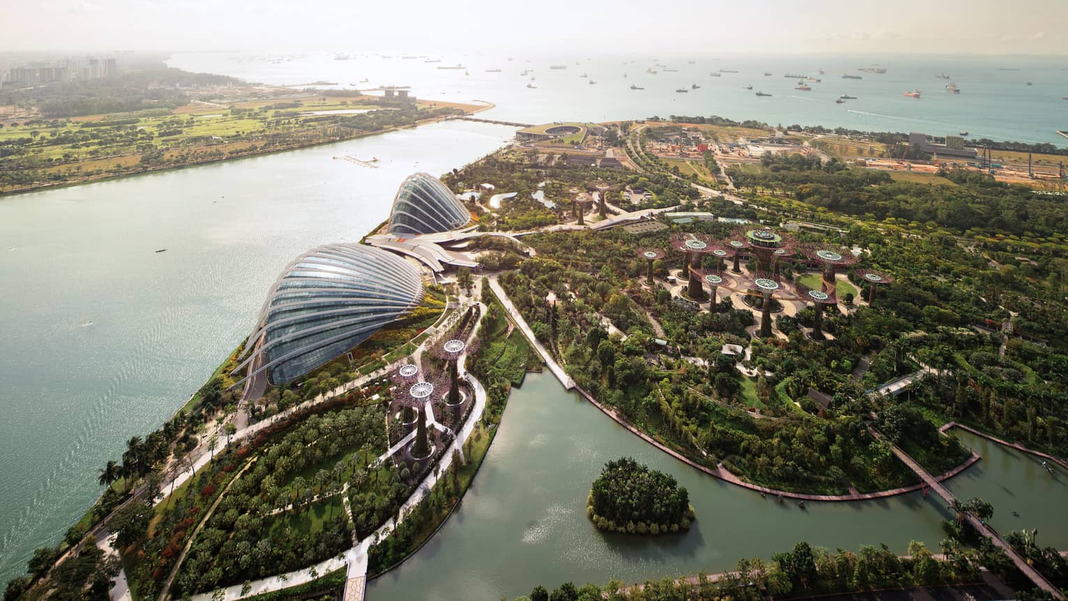 Aerial view of Singapore Gardens by the Bay trees, paths, glass domes by water 