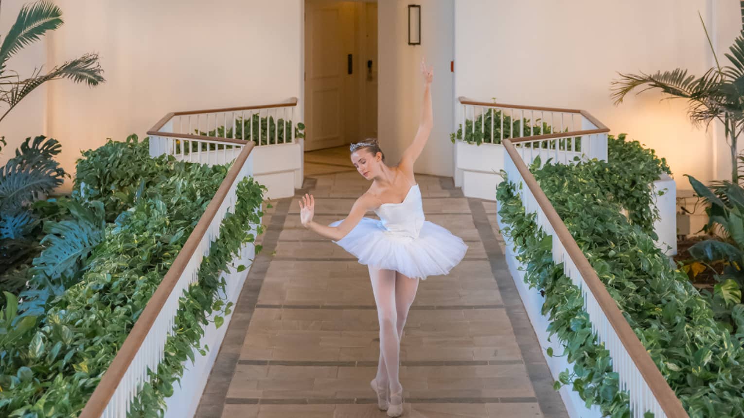 A ballet dancer performs on an outdoor walkway at resort