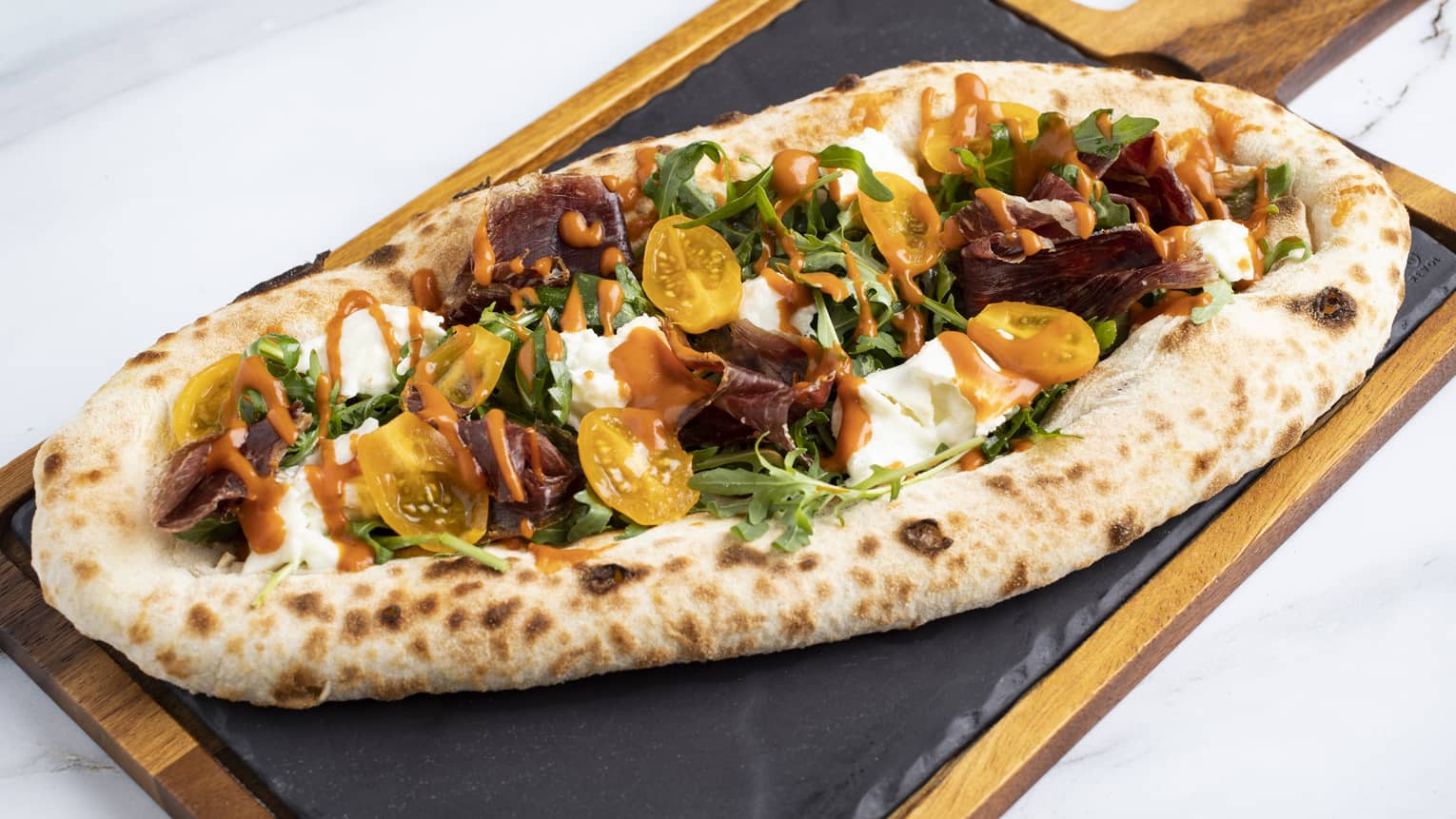 Focaccia Estate ? Mozzarella Fior di Latte, Cherry Tomatoes, Stracciatella Cheese, Wagyu Beef Coppa, Rocket Leaves and Arrabbiata Sauce