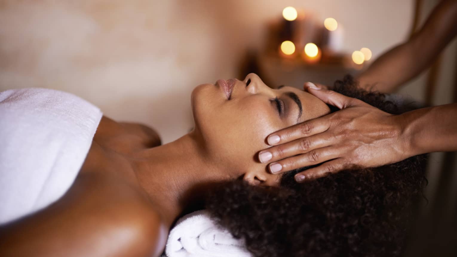 Woman laying down on massage bed getting a massage.