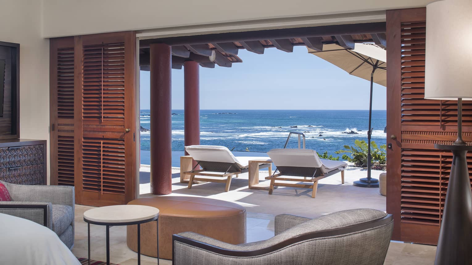 Interior photo of the 5 Bedroom Villa in Mexico, Sol. Lounge area with comfortable seating opening onto an ocean view terrace with sun loungers.