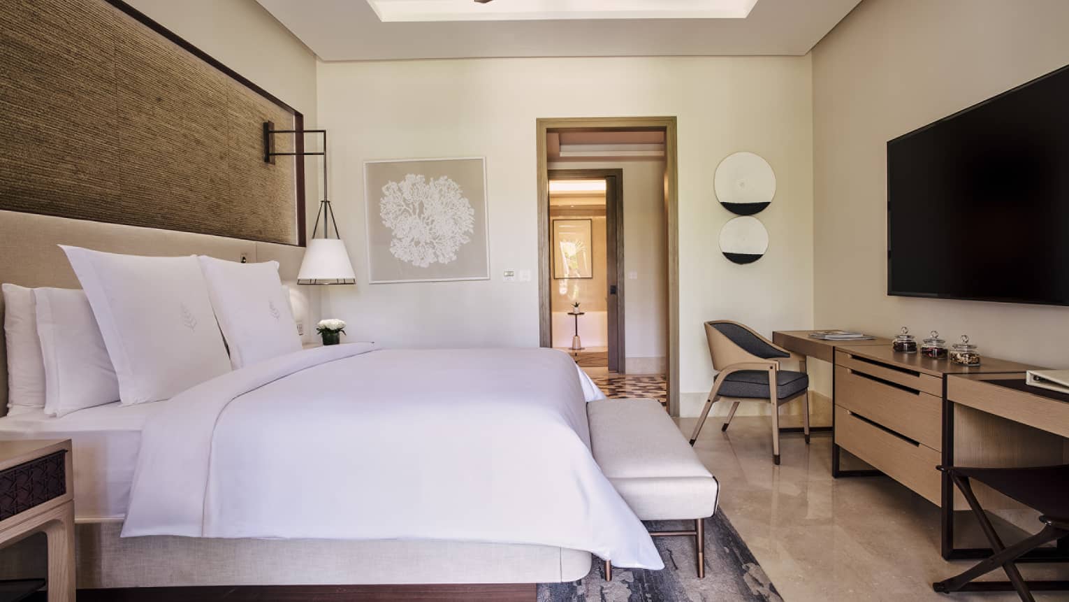 Luxury bedroom with king bed, dresser, TV and chair
