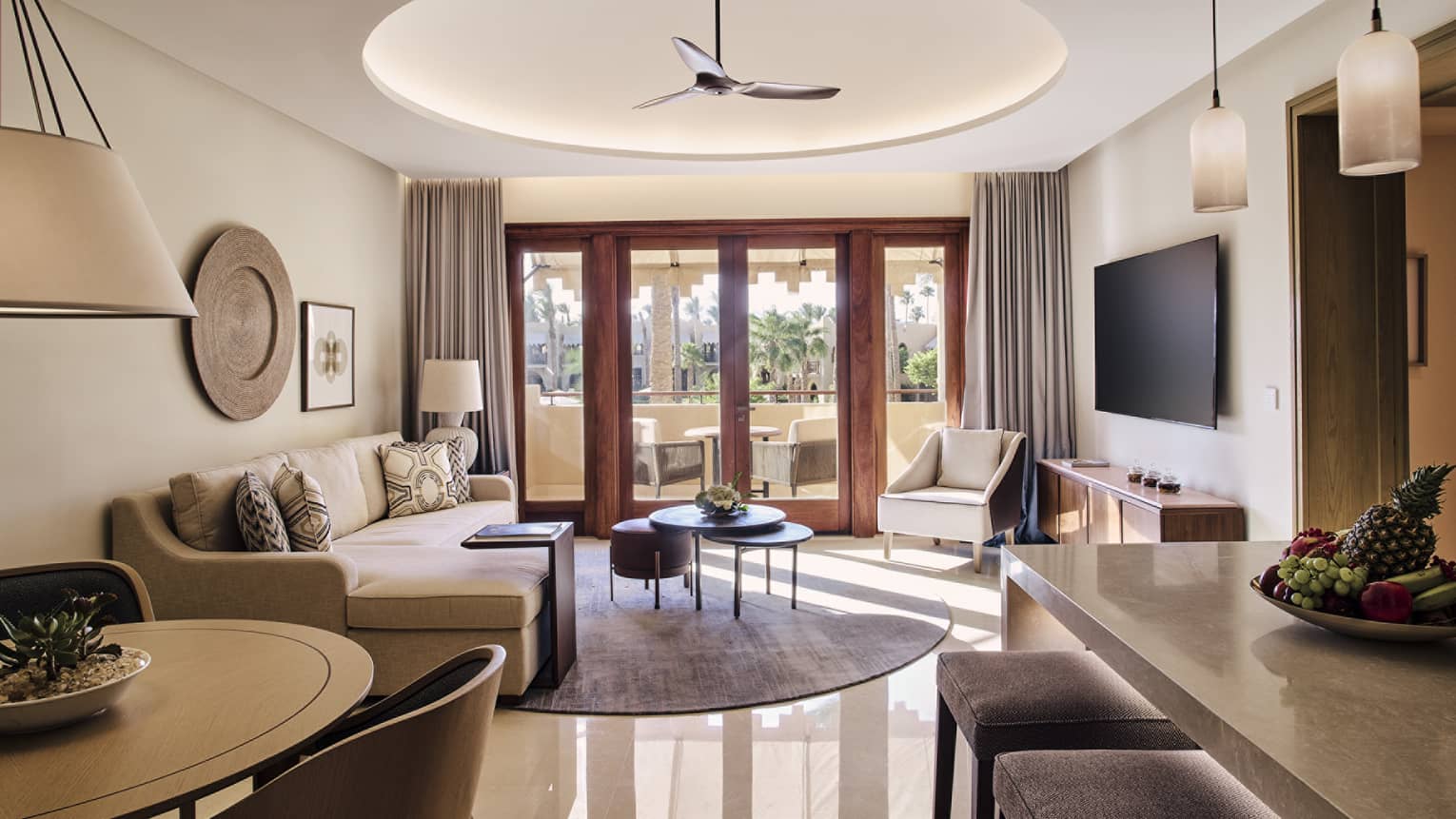 Living room featuring a sofa, dining table, TV, bar counter and walk-out terrace