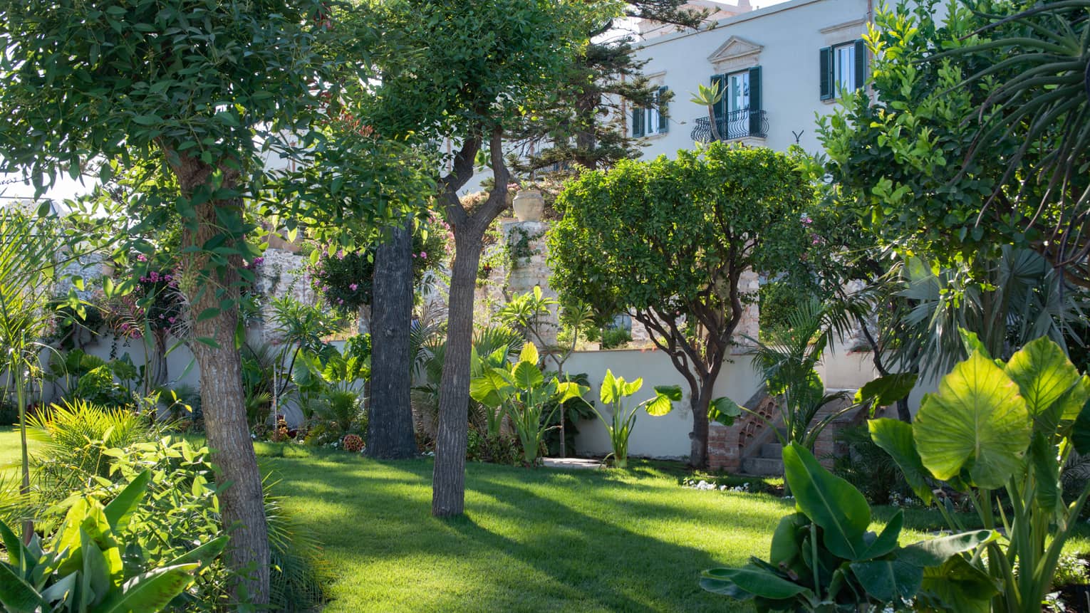 Taormina's onsite gardens with flowering trees, shrubs and bushes on a sunny day