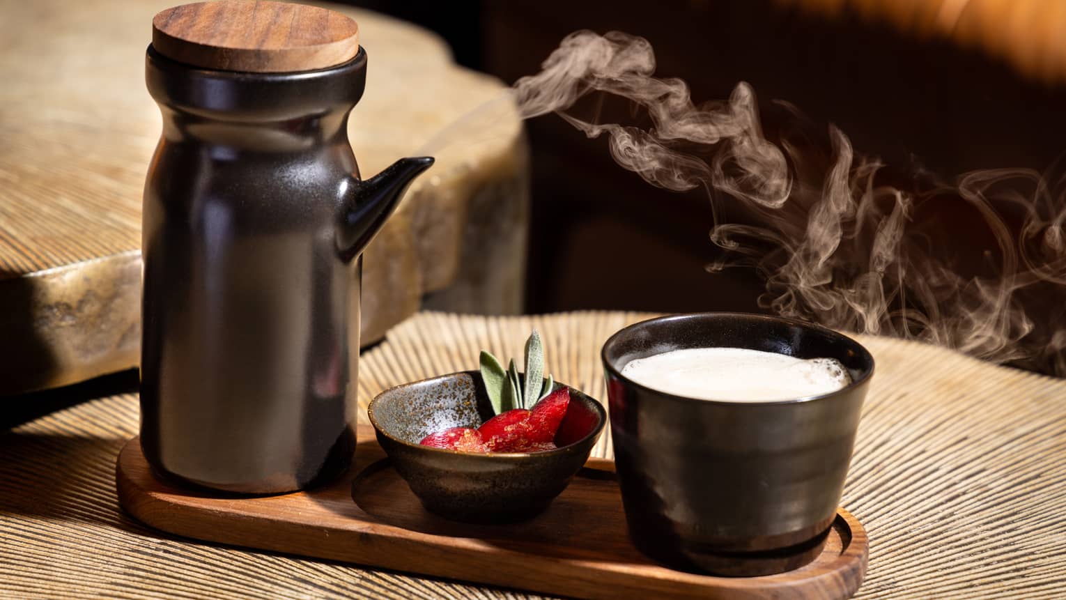 A cocktail in a small black cup.