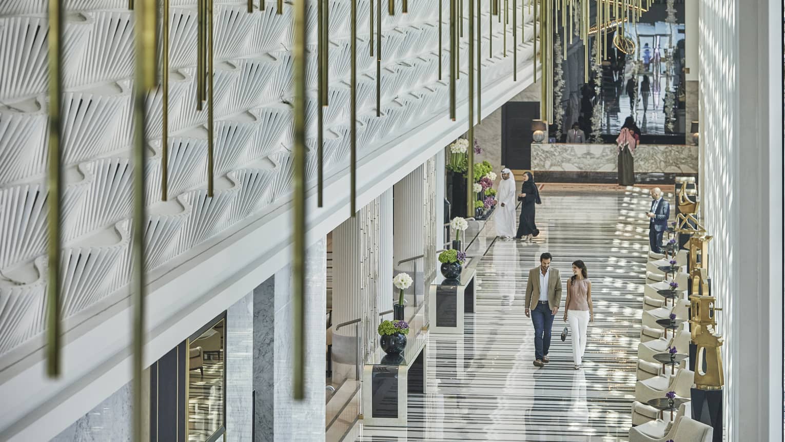 Man and woman walking in the lobby
