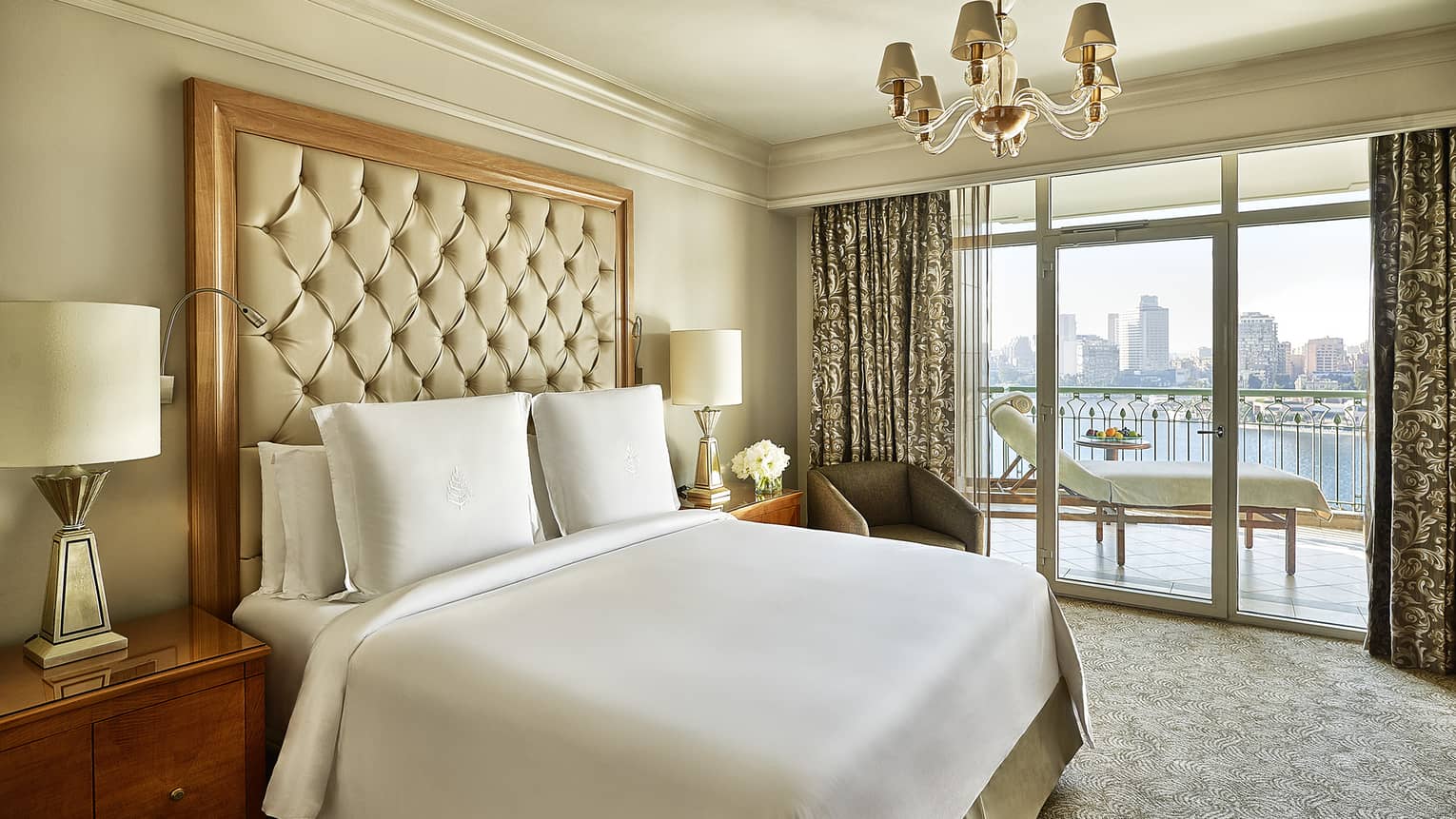 Four Seasons Suite, showing white-dressed bed and city views from windows