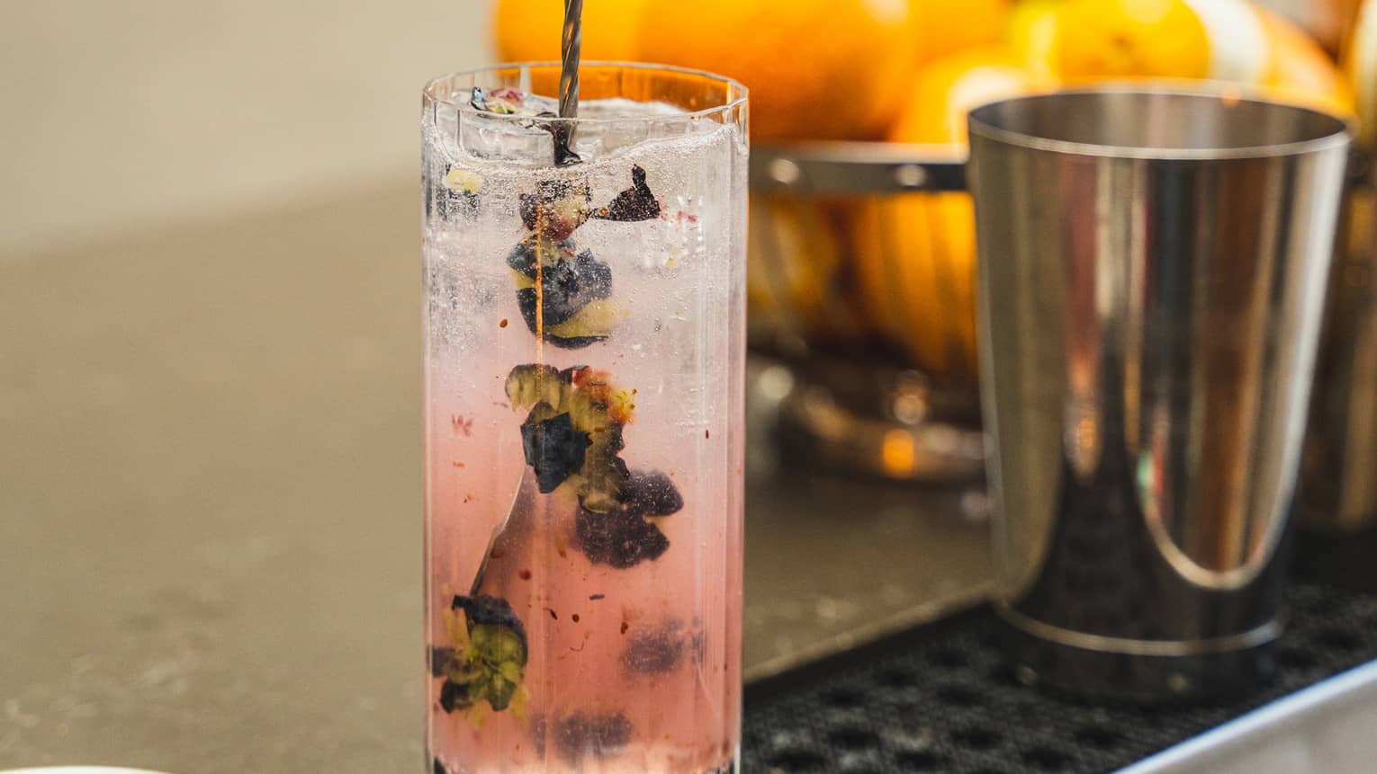 A pink cocktail with herbs.