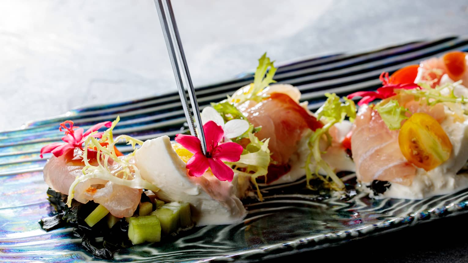 Red Mullet with little flowers and chopsticks in it.