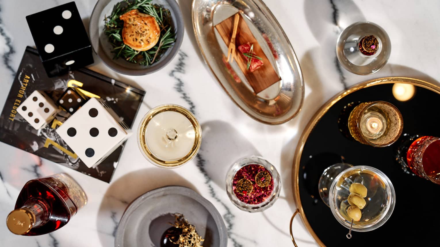 An assortment of drinks and food on metal trays and plates.