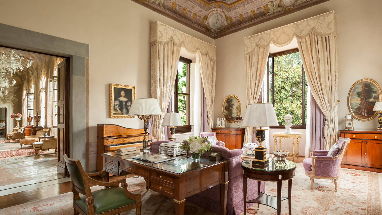 Royal Suite large wood work desk, pink silk sofa and chairs, tall windows under vaulted ceilings
