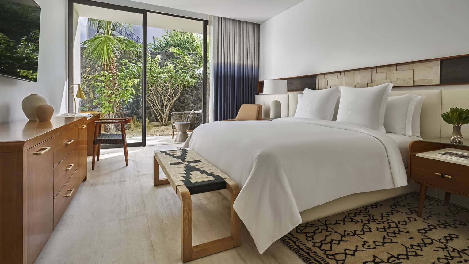 Bedroom, king bed, wooden dresser, walk-out patio with trees