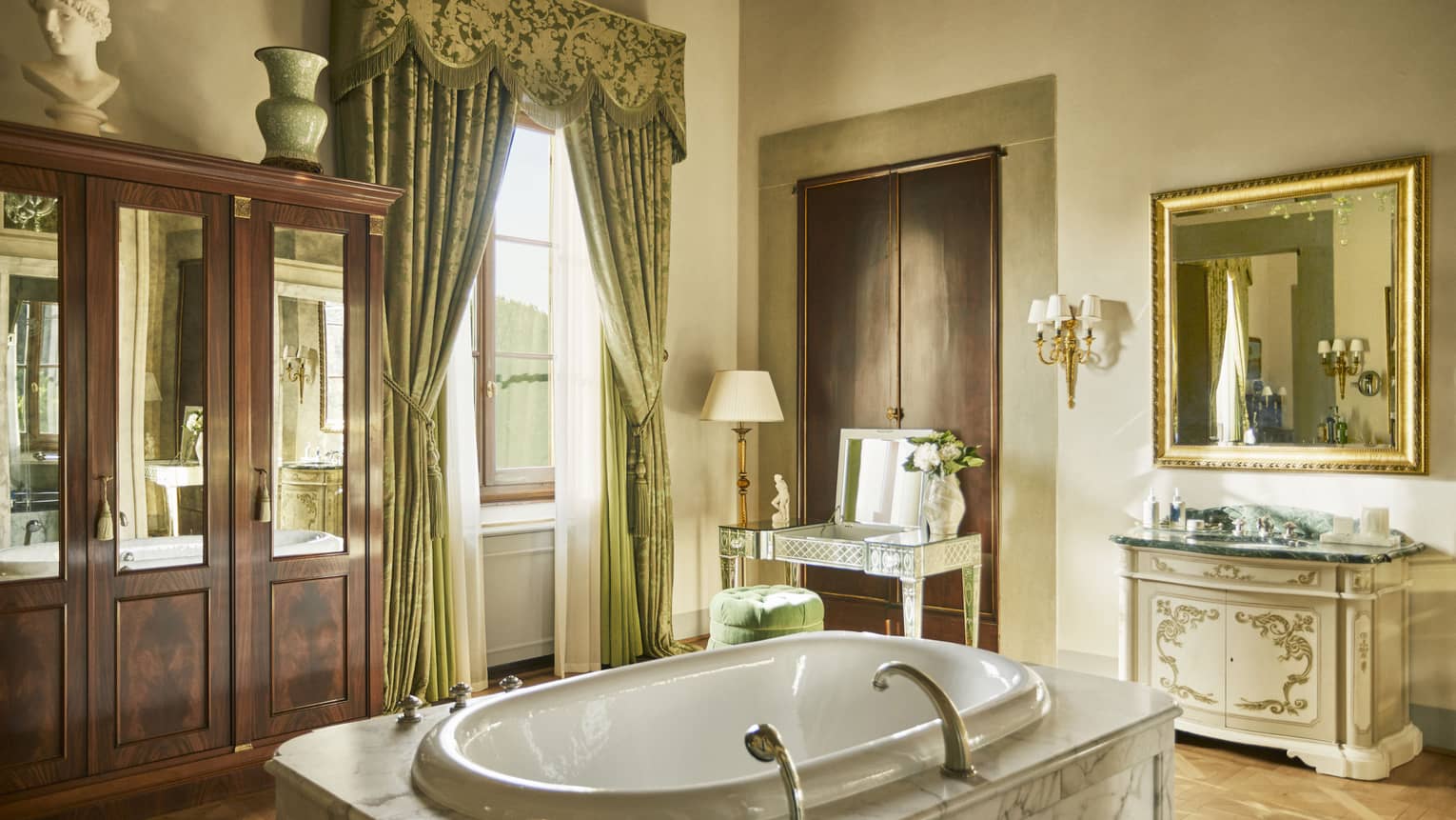 Renaissance Suite bathroom with marble tub set in the middle oft he room, wooden wardrobe and window, at Four Seasons Hotel Florence
